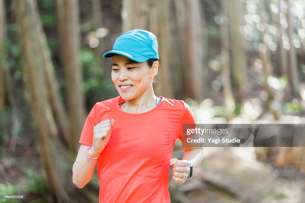 Fitness female trail runner running on a mountain path