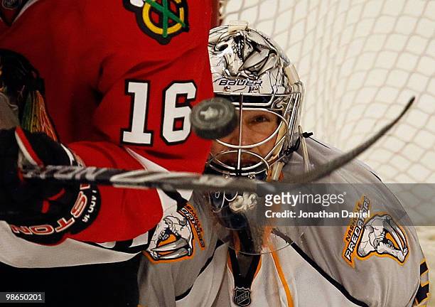 Pekka Rinne of the Nashville Predators keeps his eyes on the puck as it bounces off of the stick of Andrew Ladd of the Chicago Blackhawks in Game...