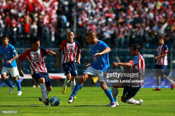 Cruz Azul's player Emanuel Villa vies for the ball with Mario Luna of Chivas Guadalajara during a 2010 Bicentenary Mexican championship soccer match...