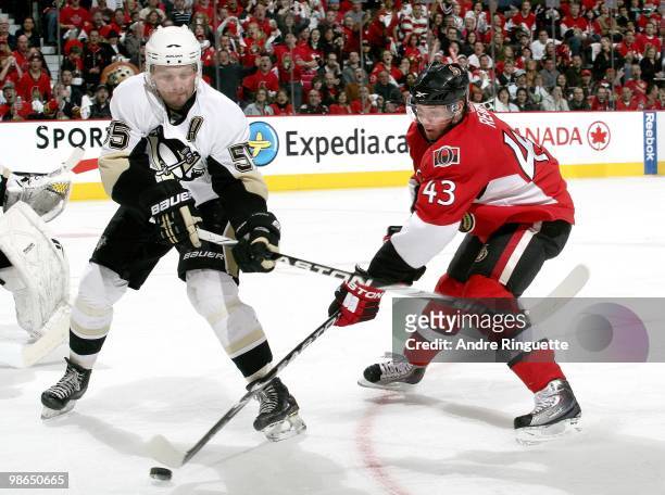 Peter Regin of the Ottawa Senators swings at the puck before Sergei Gonchar of the Pittsburgh Penguins as defends against him in Game Six of the...