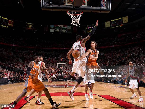 Steve Nash of the Phoenix Suns throws a pass around LaMarcus Aldridge of the Portland Trail Blazers in Game Four of the Western Conference...