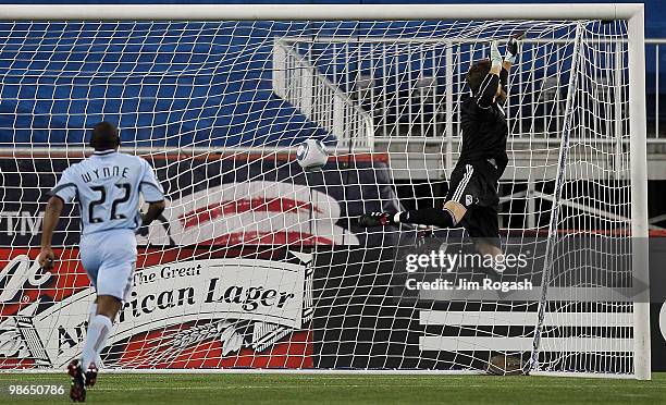 Marko Perovic of the New England Revolution scores a goal against goalie Matt Pickens and defender Marvell Wynne of the Colorado Rapids at Gillette...