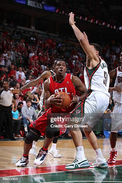 Joe Johnson of the Atlanta Hawks drives to the basket against Dan Gadzuric of the Milwaukee Bucks in Game Three of the Eastern Conference...