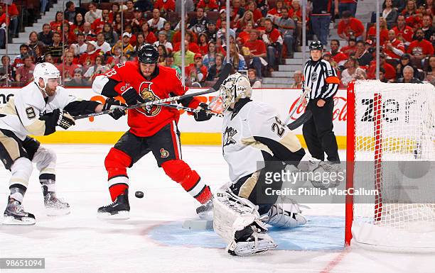 Jarkko Ruutu of the Ottawa Senators tries to get control of a rebound out front of Marc-Andre Fleury of the Pittsburgh Penguins during Game 6 of the...