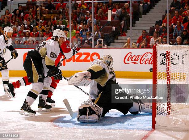 Chris Neil of the Ottawa Senators shovels a backhand shot past a sprawling Marc-Andre Fleury of the Pittsburgh Penguins during Game 6 of the Eastern...