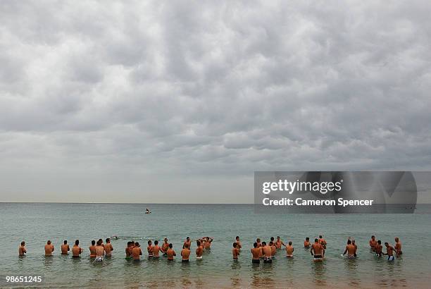 Swans players wade in the water during a Sydney Swans AFL recovery session at Coogee Beach on April 25, 2010 in Sydney, Australia.
