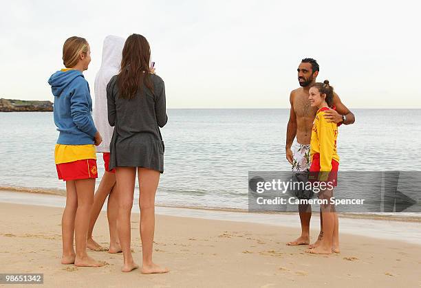 Adam Goodes of the Swans poses with lifesavers during a Sydney Swans AFL recovery session at Coogee Beach on April 25, 2010 in Sydney, Australia.