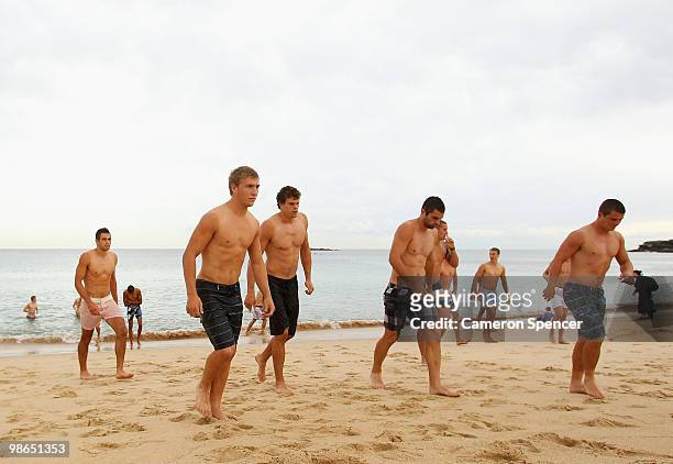 Swans players walk out of the ocean during a Sydney Swans AFL recovery session at Coogee Beach on April 25, 2010 in Sydney, Australia.