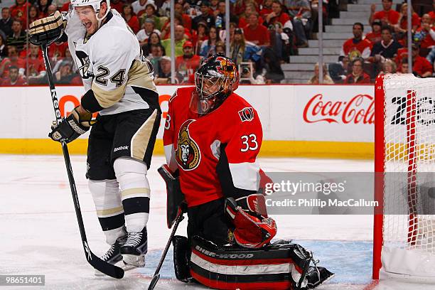 Matt Cooke of the Pittsburgh Penguins tries to deflect a point shot out front of Pascal Leclaire of the Ottawa Senators during Game 6 of the Eastern...