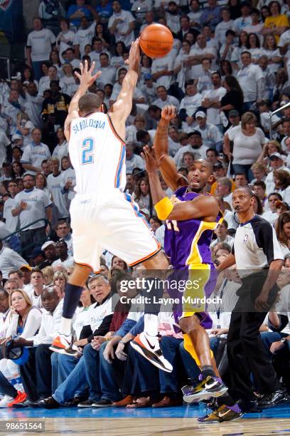 Kobe Bryant of the Los Angeles Lakers attempts to pass the ball around Thabo Sefolosha of the Oklahoma City Thunder in Game Four of the Western...