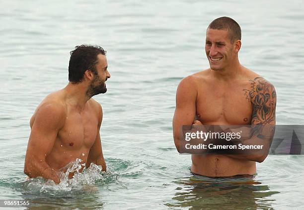 Rhyce Shaw and Jesse White of the Swans talk in the water during a Sydney Swans AFL recovery session at Coogee Beach on April 25, 2010 in Sydney,...
