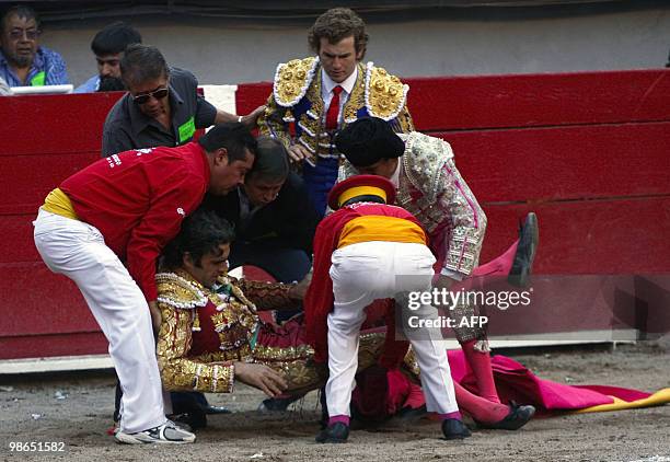 Spanish bullfighter Jose Tomas is helped after being severely gored during a bullfighting on April 24 during the San Marcos National Fair, in...