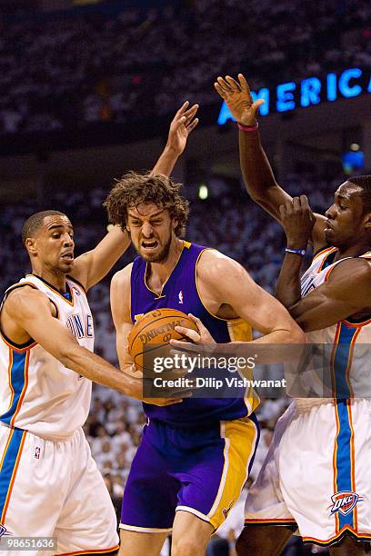 Pau Gasol of the Los Angeles Lakers pulls down a rebound against Thabo Sefolosha of the Oklahoma City Thunder during Game Four of the Western...