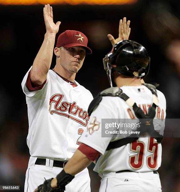 Pitcher Matt Lindstrom gives catcher Humberto Quintero a high five after the final out against the Pittsburgh at Minute Maid Park on April 24, 2010...