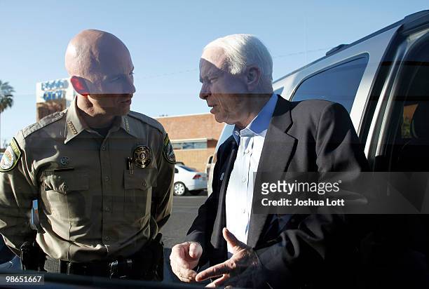 Sen. John McCain speaks with Pinal County Sheriff Paul Babeu outside VFW Post during a campaign stop on April 24, 2010 in Casa Grande, Arizona....