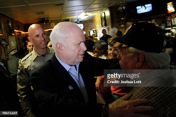 Sen. John McCain greets patrons at VFW Post as Pinal County Sheriff Paul Babeu, left, looks on during a campaign stop on April 24, 2010 in Casa...