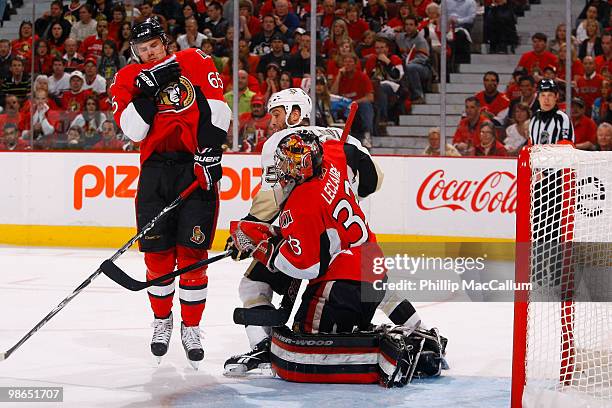 Maxime Talbot of the Pittsburgh Penguins runs into Pascal Leclaire of the Ottawa Senators as he tries to make a save during Game 6 of the Eastern...