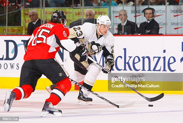 Alexei Ponikarovsky of the Pittsburgh Penguins carries the puck up ice while being watched by Erik Karlsson of the Ottawa Senators during Game 6 of...