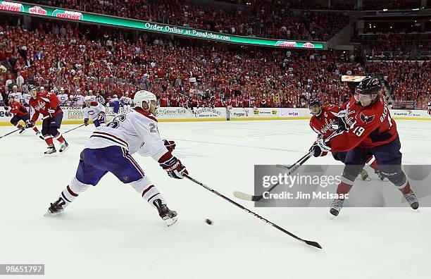 Nicklas Backstrom of the Washington Capitals shoots the puck against Josh Gorges of the Montreal Canadiens in Game Five of the Eastern Conference...