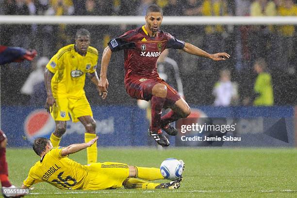 Forward Alvaro Saborio of Real Salt Lake keeps control of the ball as midfielder Brian Carroll of the Columbus Crew attempts to make a tackle on...