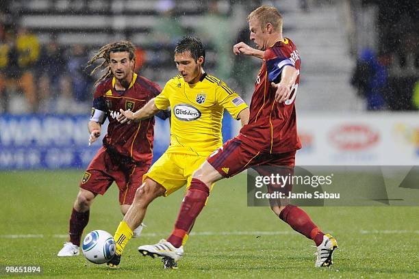 Forward Guillermo Barros Schelotto of the Columbus Crew splits through the defense of midfielder Kyle Beckerman and defenseman Nat Borchers, both of...