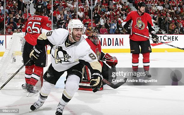 Pascal Dupuis of the Pittsburgh Penguins celebrates his overtime, series clinching goal against Erik Karlsson, Pascal Leclaire and Andy Sutton of the...