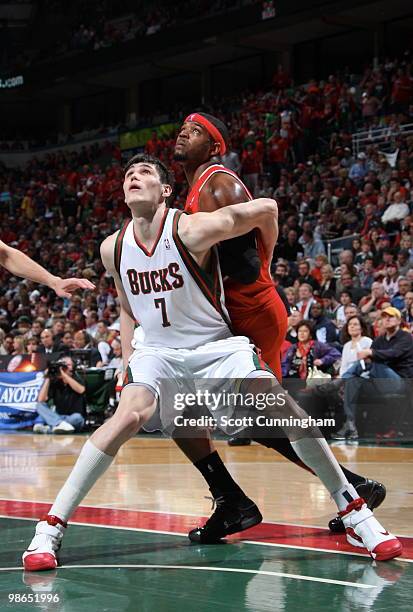 Ersan Ilyasova of the Milwaukee Bucks boxes out against Josh Smith of the Atlanta Hawks in Game Three of the Eastern Conference Quarterfinals during...