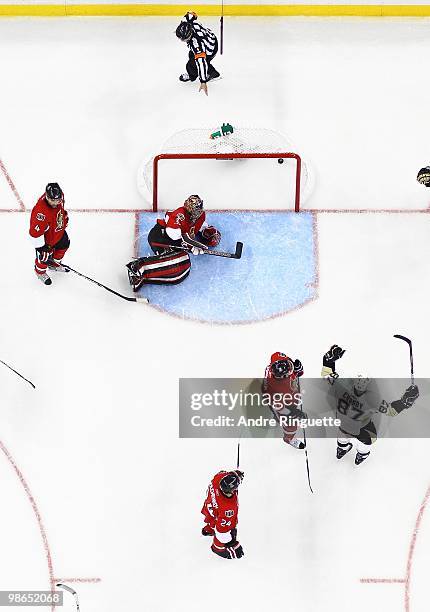 Referee Wes McCauley signals a goal against Chris Phillips, Pascal Leclaire, Anton Volchenkov and Daniel Alfredsson of the Ottawa Senators as Sidney...