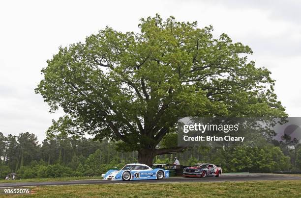 The BMW Riley of Scott Pruett and Memo Rojas races past the Oak Tree during the Bosch Engineering 250 at Virginia International Raceway on April 24,...