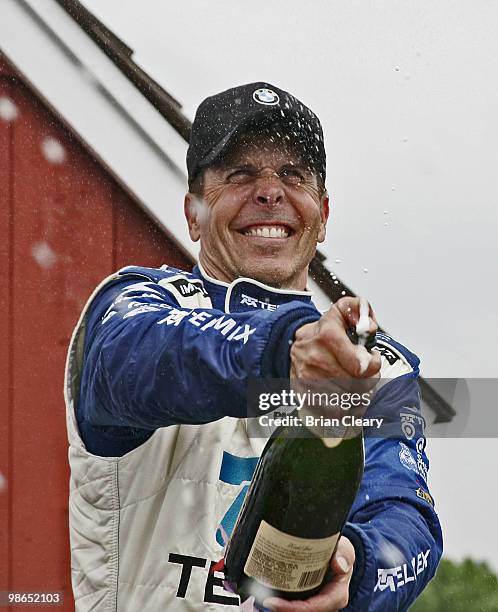 Scott Pruett sprays champagne in victory lane after the Bosch Engineering 250 at Virginia International Raceway on April 24, 2010 in Alton, Virginia.