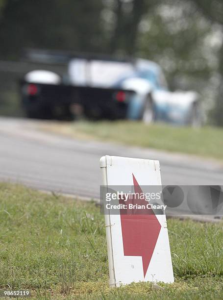 Car races past a turn arrow during the Bosch Engineering 250 at Virginia International Raceway on April 24, 2010 in Alton, Virginia.