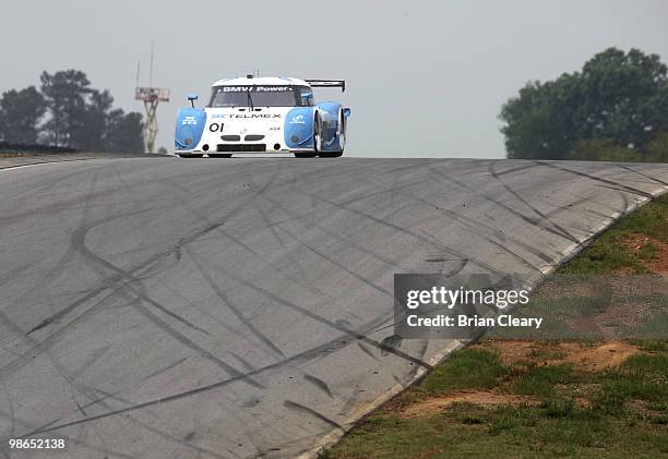 The BMW Riley of Scott Pruett and Memo Rojas crests a hill during the Bosch Engineering 250 at Virginia International Raceway on April 24, 2010 in...