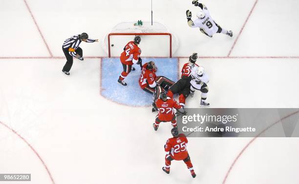 Pascal Dupuis and Matt Cooke of the Pittsburgh Penguins celebrate a goal against Chris Campoli, Pascal Leclaire, Matt Carkner, Chris Neil and Chris...