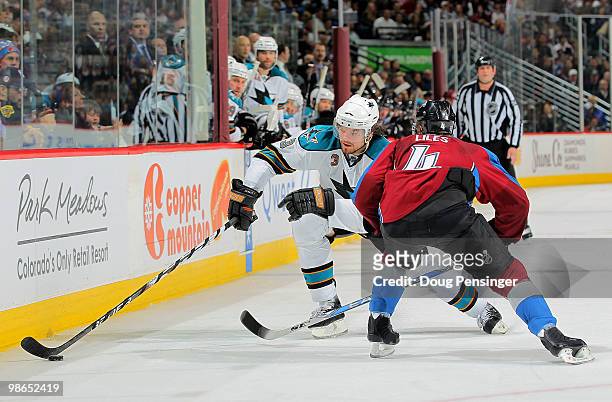 Douglas Murray of the San Jose Sharks controls the puck as John-Michael Liles of the Colorado Avalanche defends during Game Six of the Western...