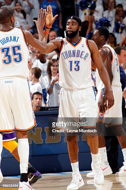 James Harden of the Oklahoma City Thunder is given a high five from team mate Kevin Durant after completing a four point play in Game Four of the...