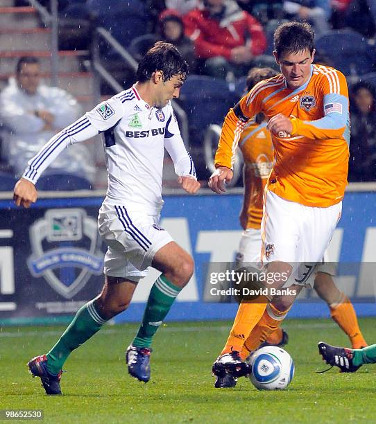 Baggio Husidic of the Chicago Fire and Bobby Boswell of the Houston Dynamo go for the loose ball in an MLS match on April 24, 2010 at Toyota Park in...