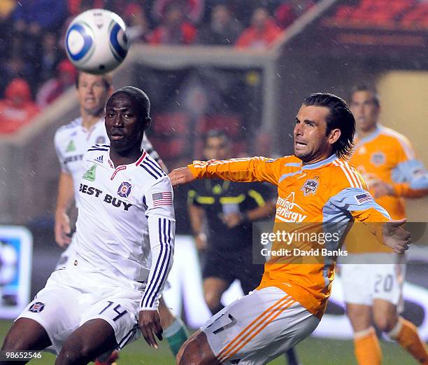 Patrick Nyarko of the Chicago Fire and Mike Chabala of the Houston Dynamo go for the loose ball in an MLS match on April 24, 2010 at Toyota Park in...