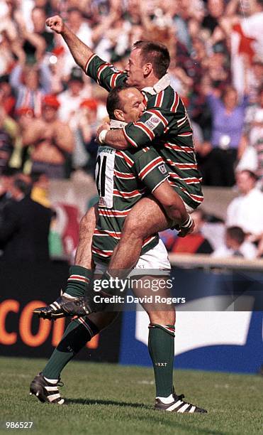 Pat Howard is lifted by Perry Freshwater as they celebrate winning the Heineken Cup during the match between Stade Francais and Leicester Tigers in...