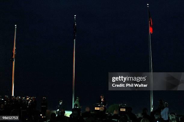 New Zealand Prime Minister John Key speaks under the Australian, New Zealand and Turkish flags during the ANZAC Day Dawn Service at ANZAC Cove on...