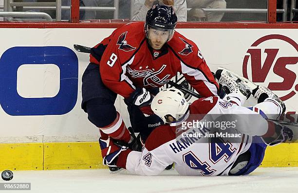 Brendan Morrison of the Washington Capitals battles for the puck against Roman Hamrlik of the Montreal Canadiens in Game Five of the Eastern...