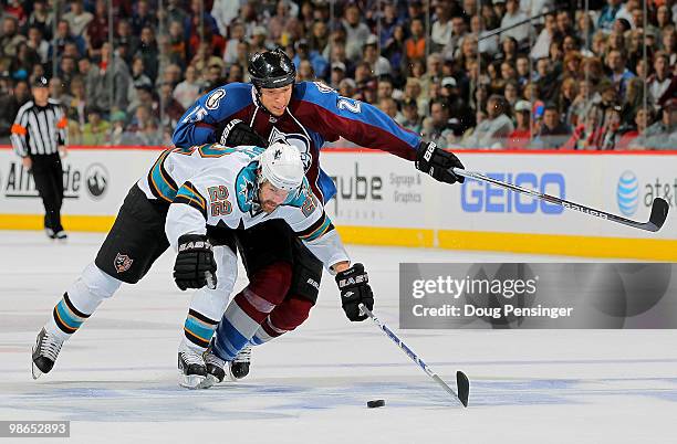 Dan Boyle of the San Jose Sharks and Chris Stewart of the Colorado Avalanche battle for control of the puck in Game Six of the Western Conference...