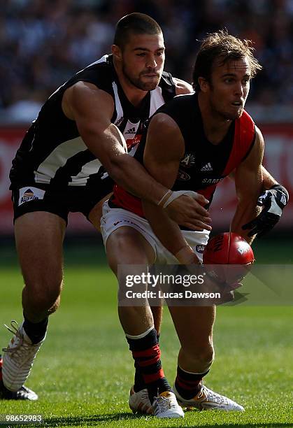 Andrew Welsh of the Bombers hanballs the ball during the round five AFL match between the Collingwood Magpies and the Essendon Bombers at Melbourne...