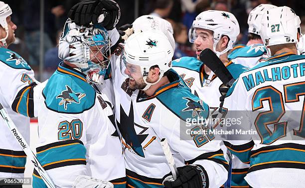 Goaltender Evgeni Nabokov is congratulated by teammate Dan Boyle of the San Jose Sharks following a game against the Colorado Avalanche in game Six...