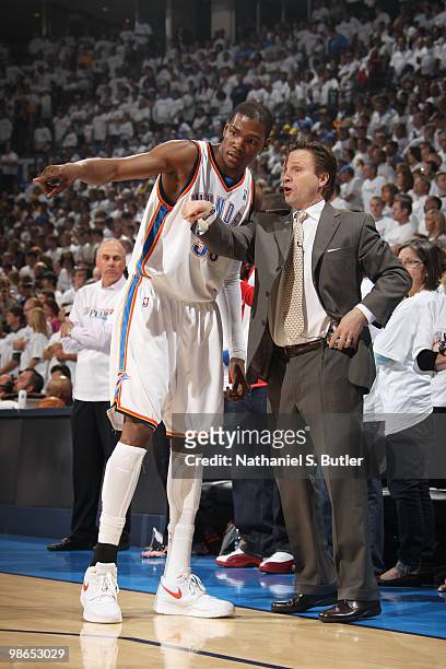 Coach Scott Brooks and Kevin Durant of the Oklahoma City Thunder speak to each other while their team plays against the Los Angeles Lakers in Game...