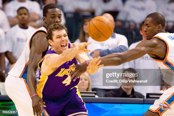 Luke Walton of the Los Angeles Lakers passes the ball against Jeff Green and Serge Ibaka both of the Oklahoma City Thunder during Game Four of the...