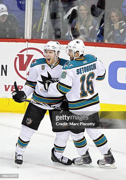 Joe Pavelski of the San Jose Sharks celebrates with teammate Devin Setoguchi after Pavelski scored what would turn out to be the game winner in the...