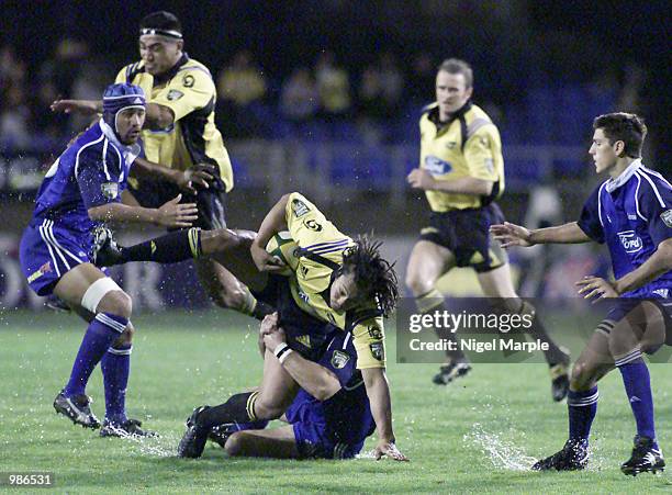 Tana Umaga of the Hurricanes takes a spill as he is tackled during the Super 12 match between the Blues and the Hurricanes at Eden Park, Auckland,...