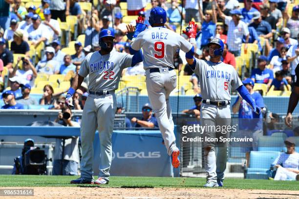 Chicago Cubs second baseman Javier Baez leaps to high five Chicago Cubs right fielder Jason Heyward and Chicago Cubs outfielder Albert Almora Jr....