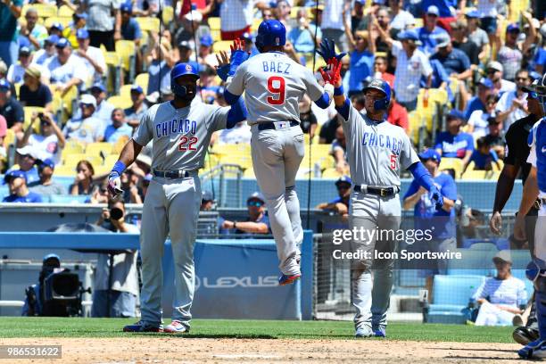 Chicago Cubs second baseman Javier Baez leaps to high five Chicago Cubs right fielder Jason Heyward and Chicago Cubs outfielder Albert Almora Jr....