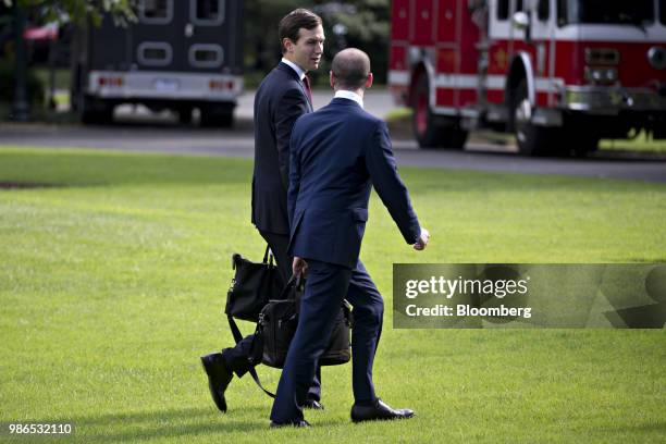 Jared Kushner, senior White House adviser, left, talks to Stephen Miller, White House senior advisor for policy, after arriving on Marine One on the...